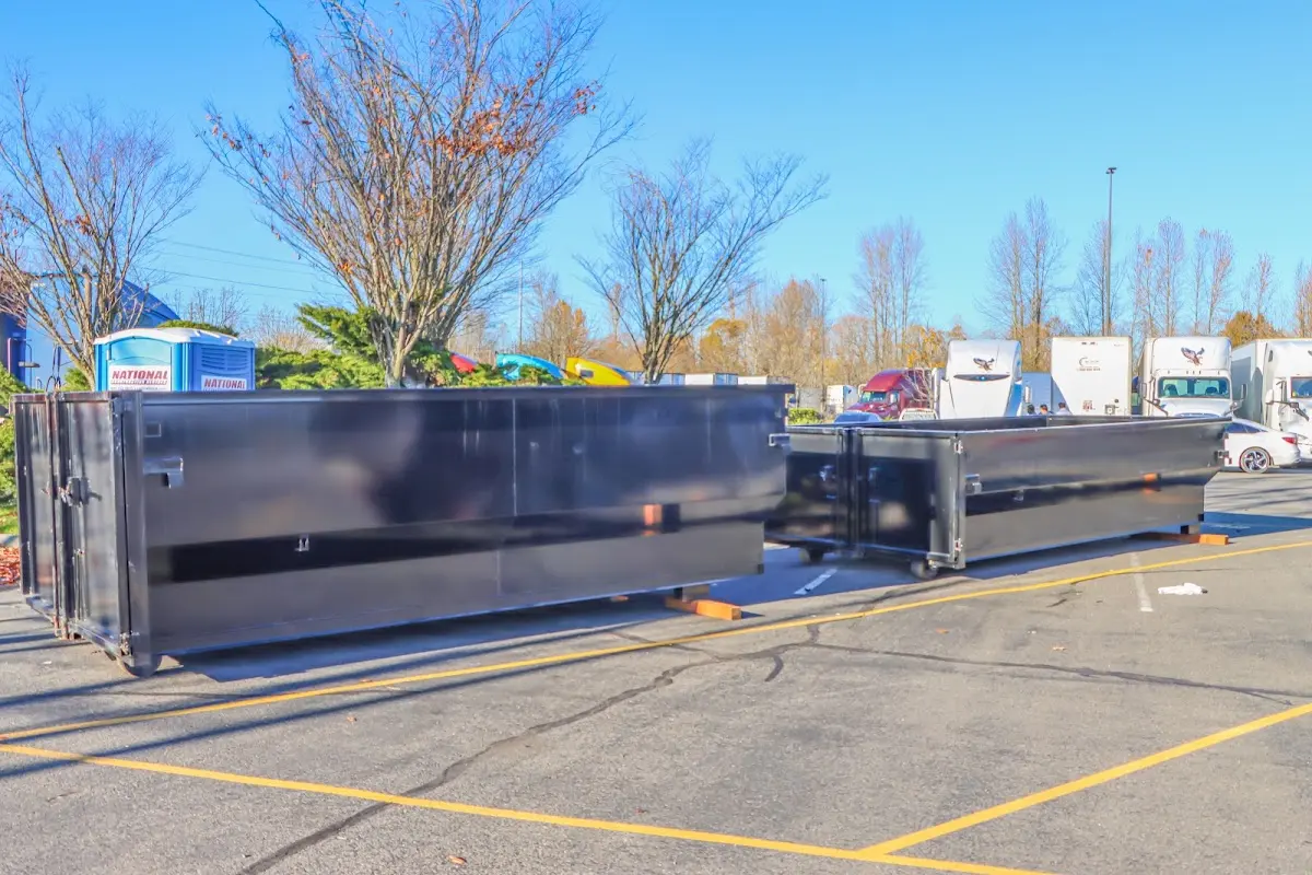 Professional dumpster rental service with roll-off container on residential driveway in Saco